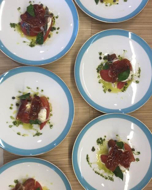 Heirloom tomato salad with crisp prosciutto and basil, luxury yacht lunch service