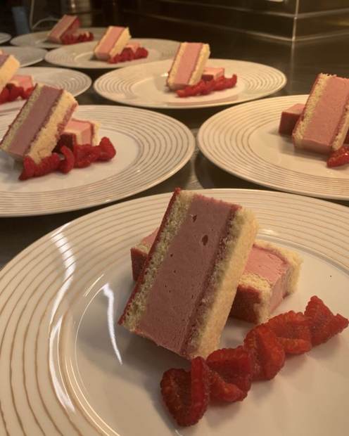 Raspberry and vanilla layered dessert slices plated for full guest service aboard a yacht