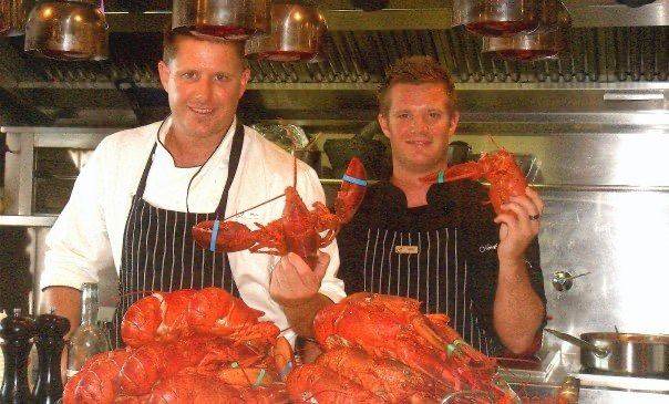 Chefs with a mountain of fresh lobsters
