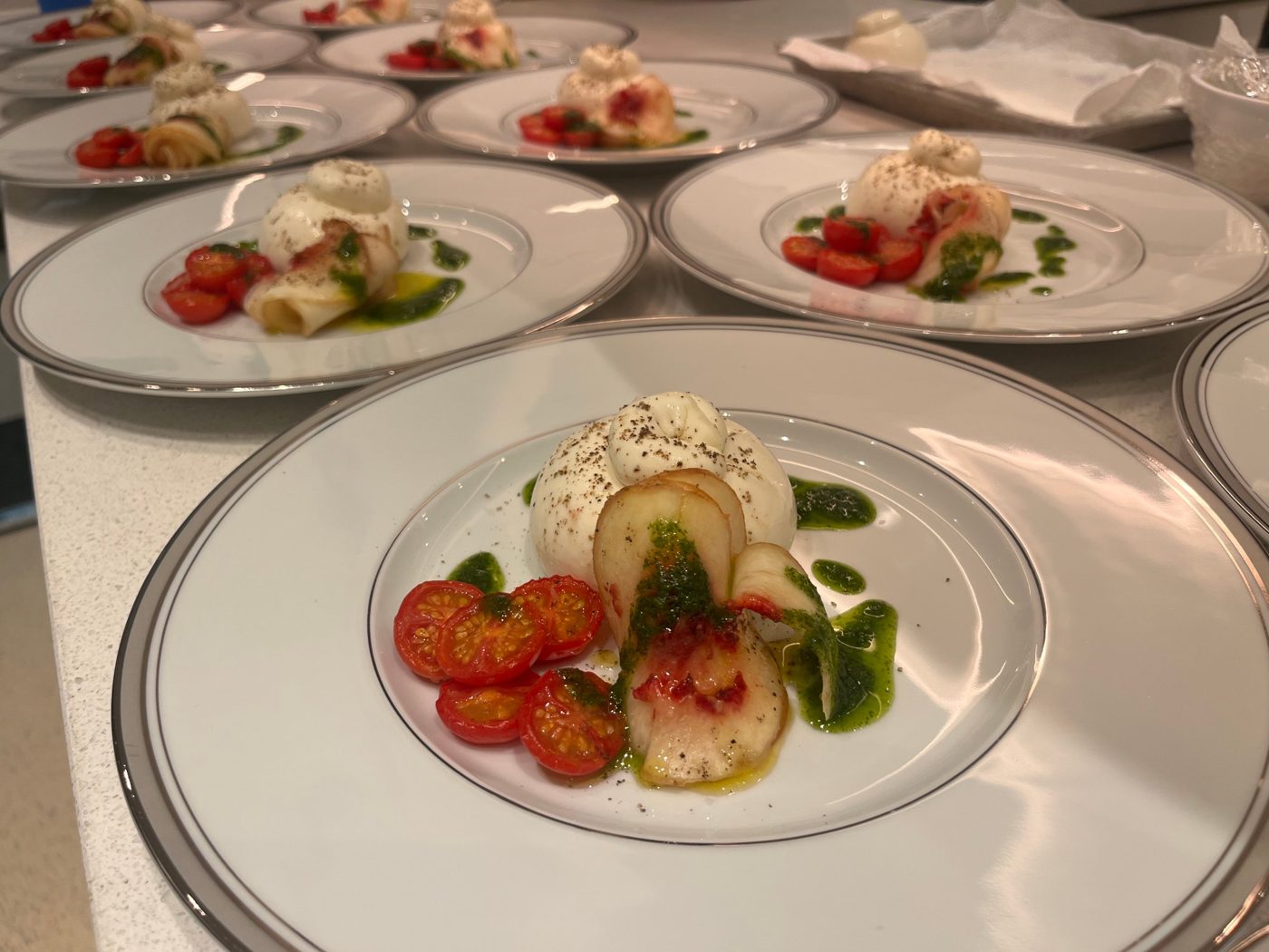 Burrata with white peach, slow-roasted tomatoes and basil oil by chef Troy Davidson
