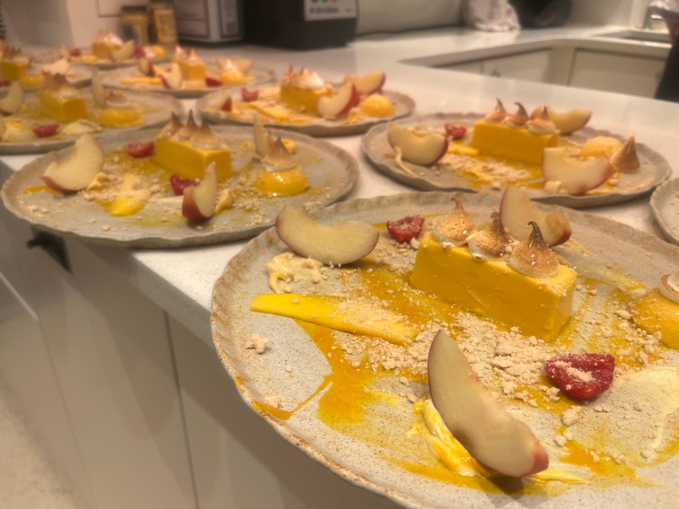 Mango parfait with torched meringue, white peach and raspberry for a full guest service by chef Troy Davidson